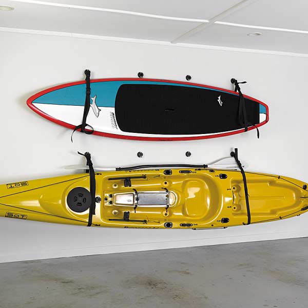Two kayaks slung on wall using the sling
