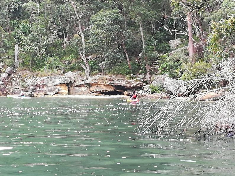 Kayakers paddling down Waterfall Bay