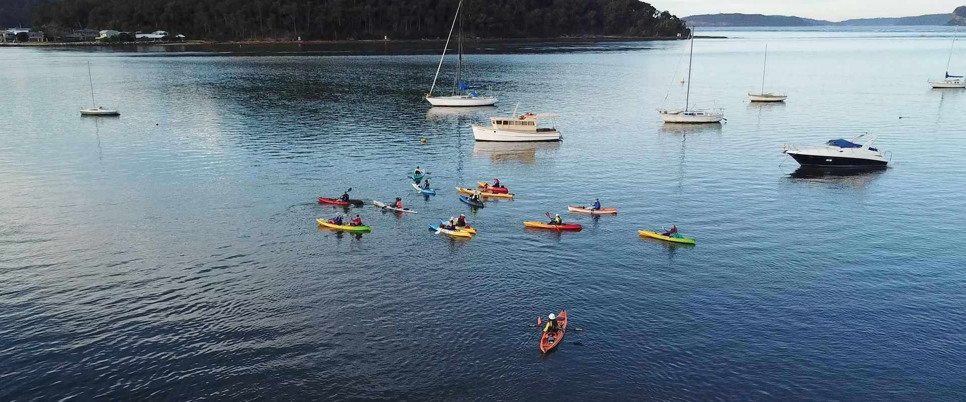 Group of kayakers paddling in Central Coast lake
